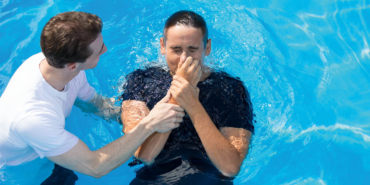 A young man getting baptized.