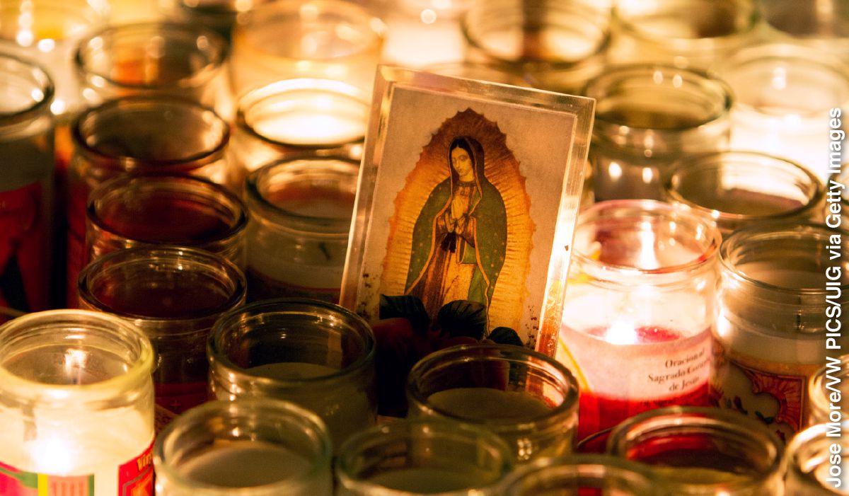 Lighted candles surround a picture of Mary during the Fiesta of Our Lady of Guadalupe