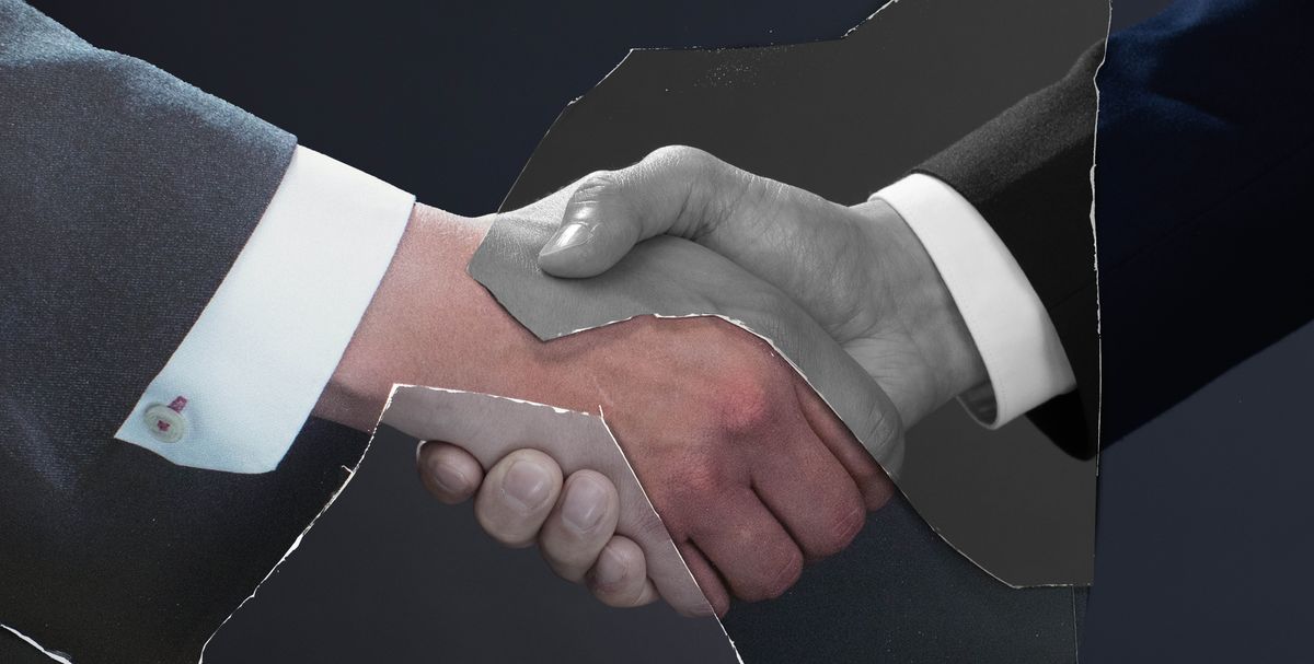 A torn photograph containing two hands shaking in agreement.