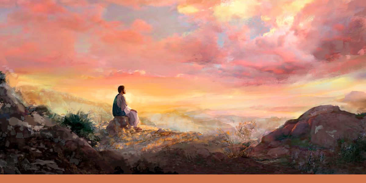Jesús en el desierto de Judea sentado en un terreno rocoso y meditando.