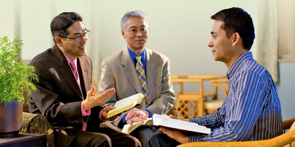 Two elders make a shepherding call on a brother