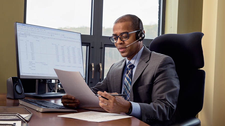 One of Jehovah’s Witnesses working at a desk handles administrative tasks.