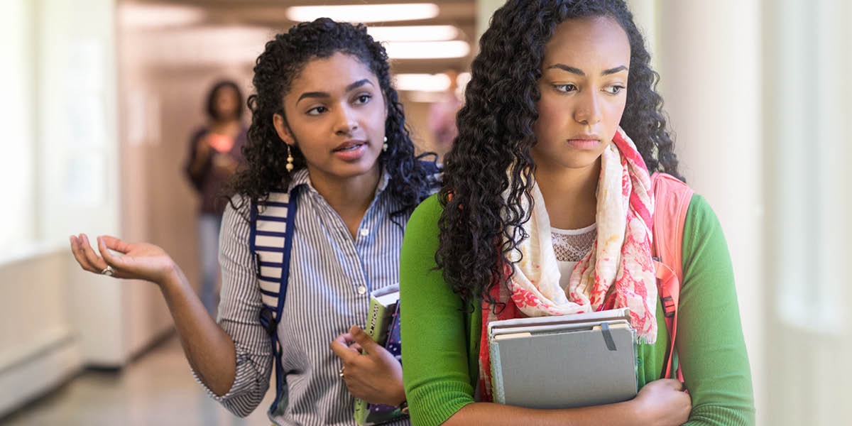 A girl says hurtful things to another girl