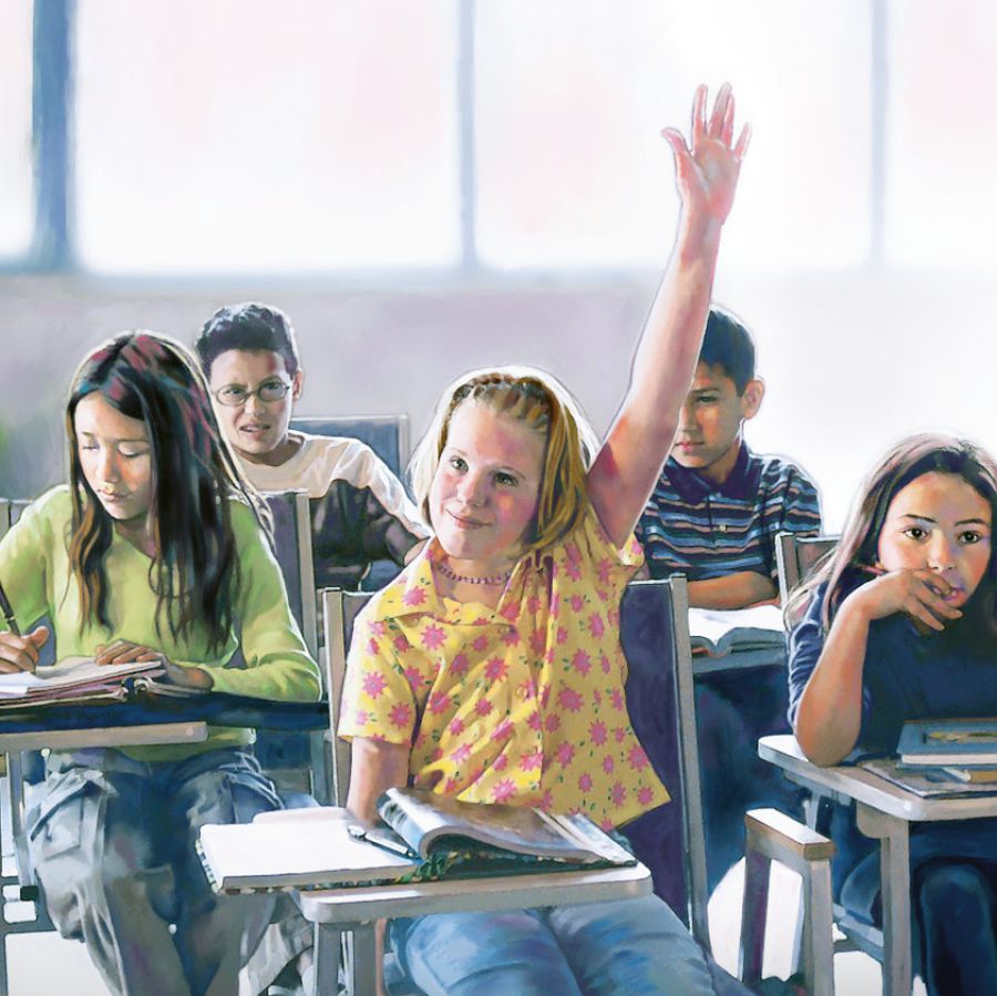 A girl raises her hand in a classroom