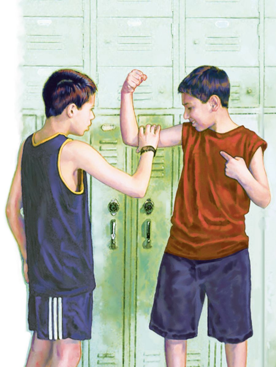 A boy shows his muscles to another boy