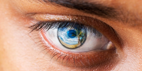 A picture of paradise is superimposed on a human eye