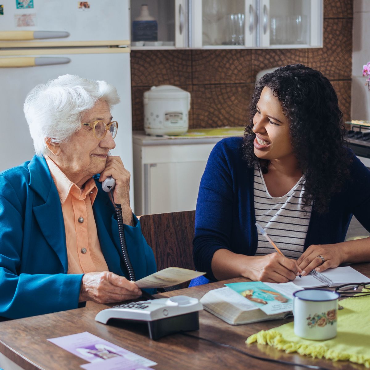A sister participating in telephone witnessing with an older sister and speaking encouragingly to her.