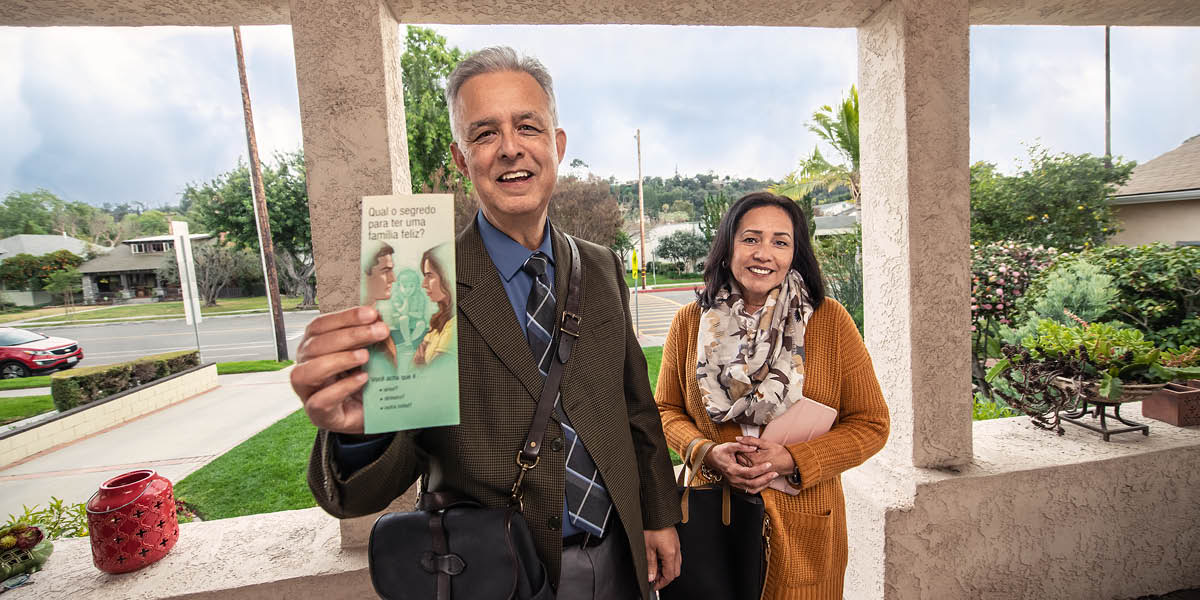 Un hermano y una hermana mostrando un tratado a través de una cámara.