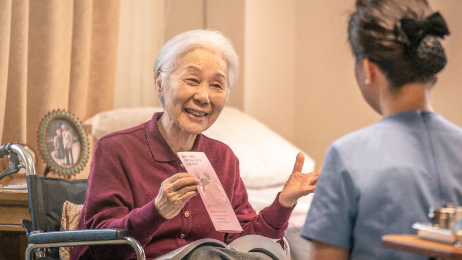 一位坐輪椅的老姐妹給醫療人員一張傳單