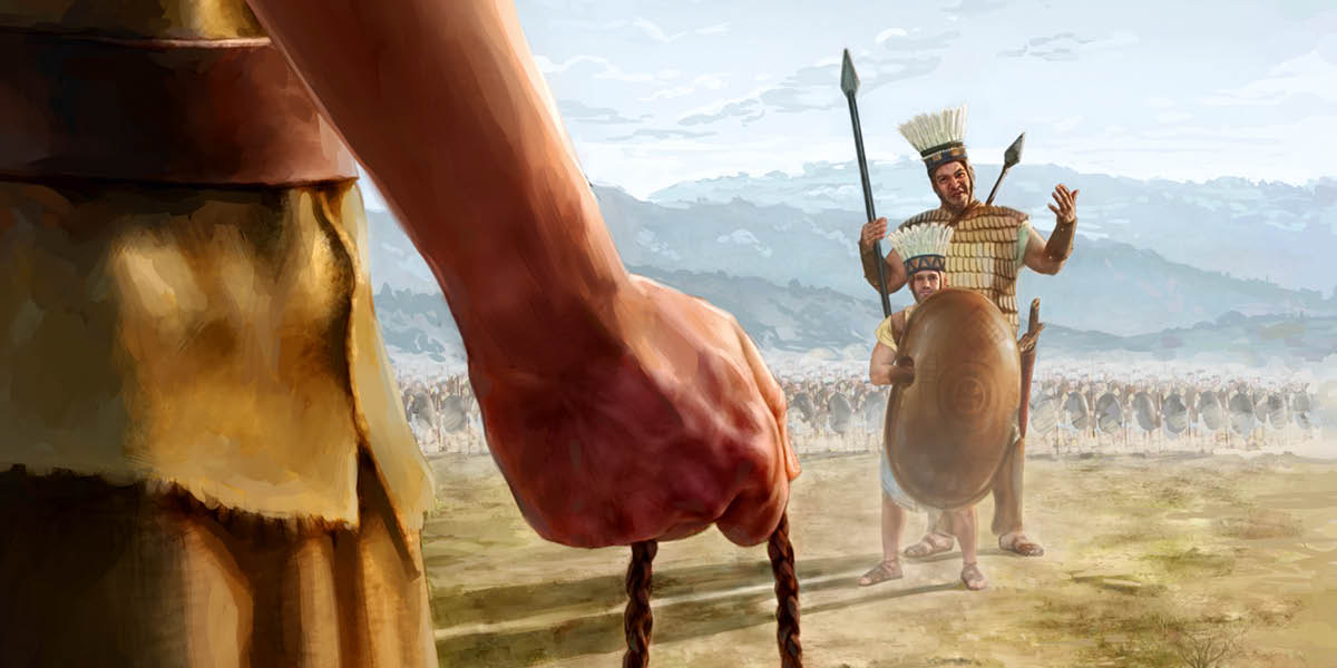 Goliáš, který je o hodně vyšší než jeho zbrojnoš, stojí na bojišti a vysmívá se Davidovi