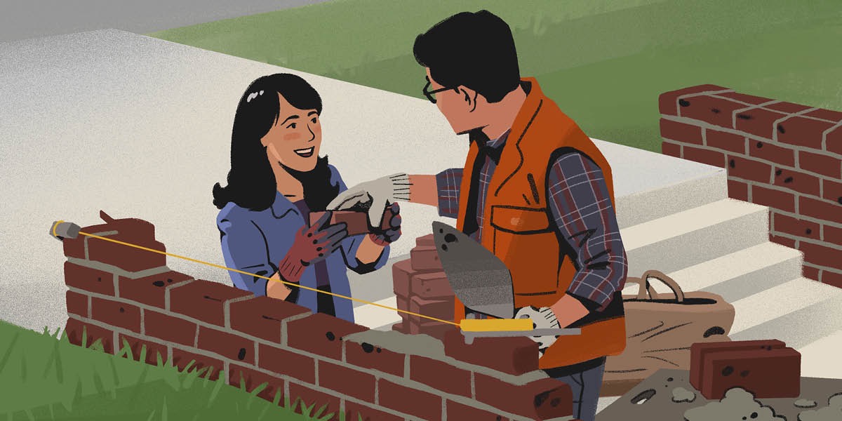 Un matrimonio usa cemento para colocar ladrillos