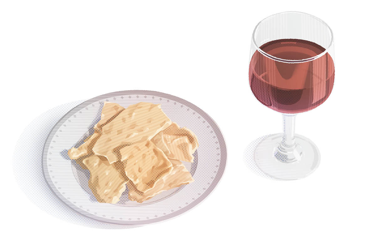 Un plato con pan sin levadura y una copa de vino.