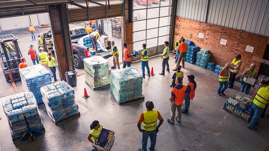En un almacén, varios Testigos juntan provisiones para ayuda humanitaria.