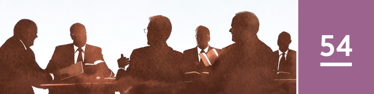 Lección 54. El Cuerpo Gobernante de los Testigos de Jehová en una sala de reuniones.