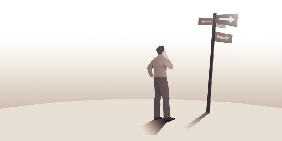 A man contemplates signs at a crossroad