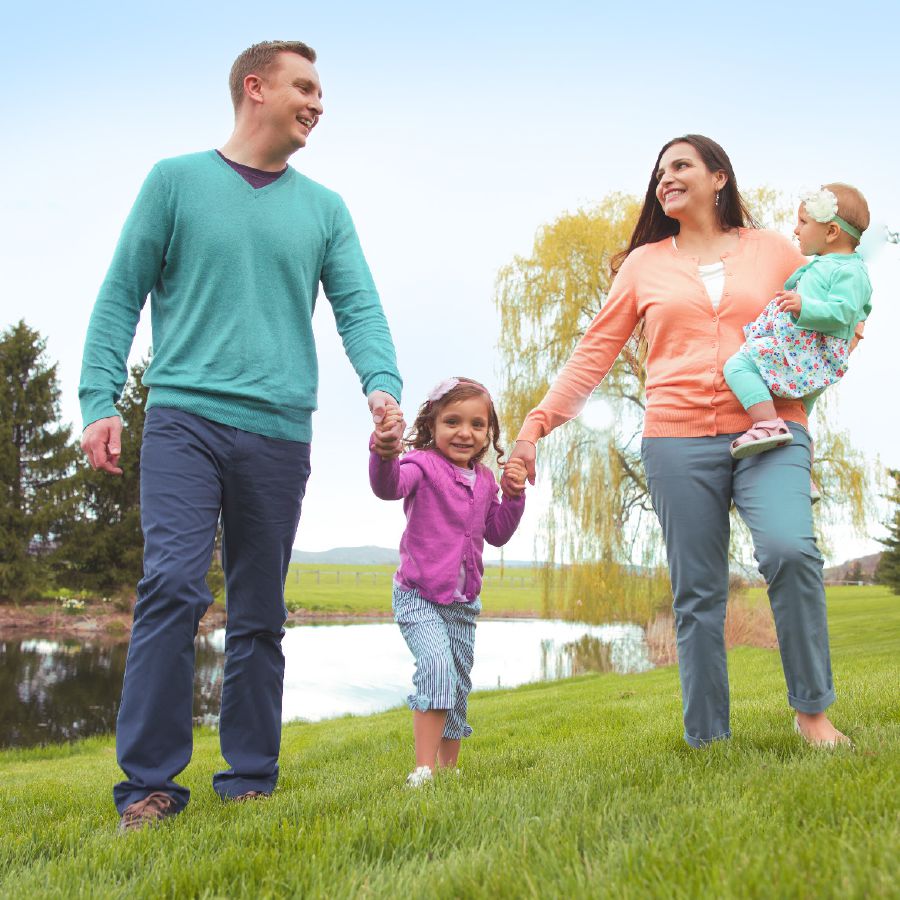 A husband and wife and their two children spend time outdoors together