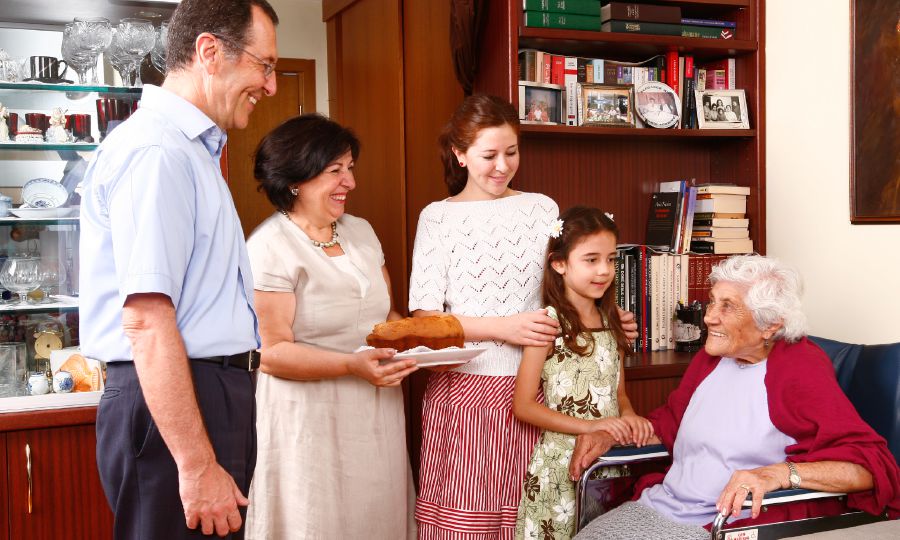 A family brings an elderly woman food