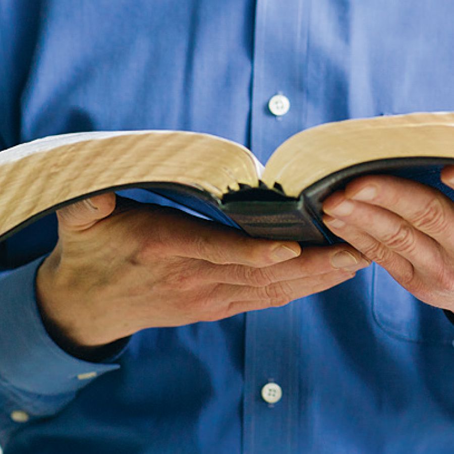A man holds the Holy Scriptures