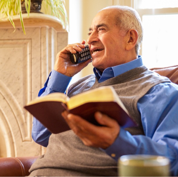 An older brother uses the telephone to share a scriptural point