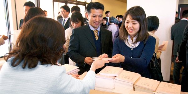 Publishers at the special meeting happily receive their new publication