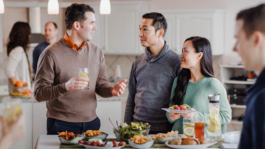 The brother conversing with others from the congregation at a social gathering.