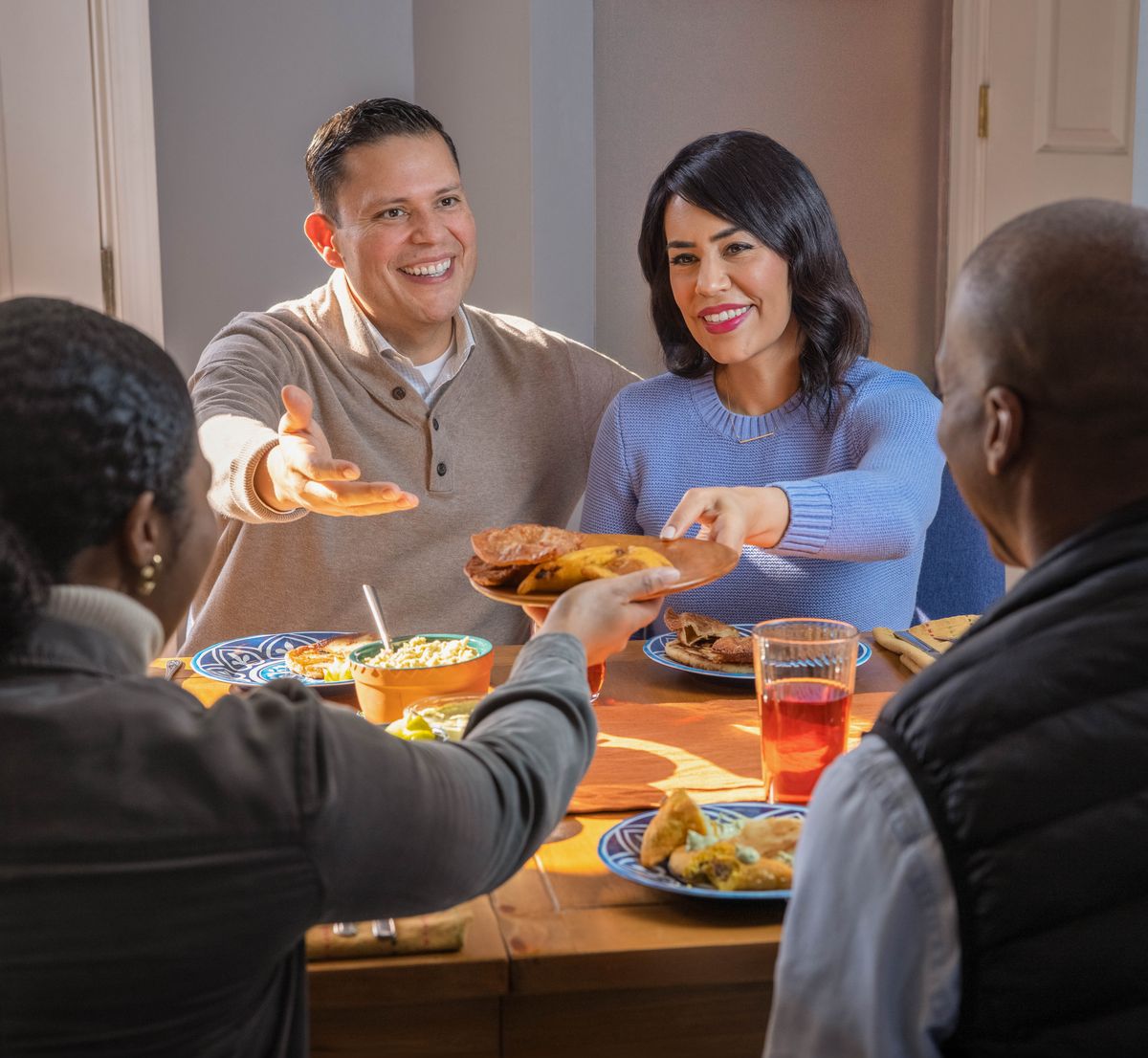 Two couples enjoying a meal together.