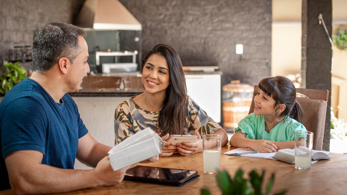 The mother happily joins her husband and young daughter for family worship.