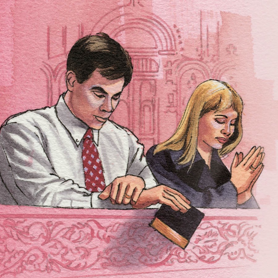 Un couple prie dans une église