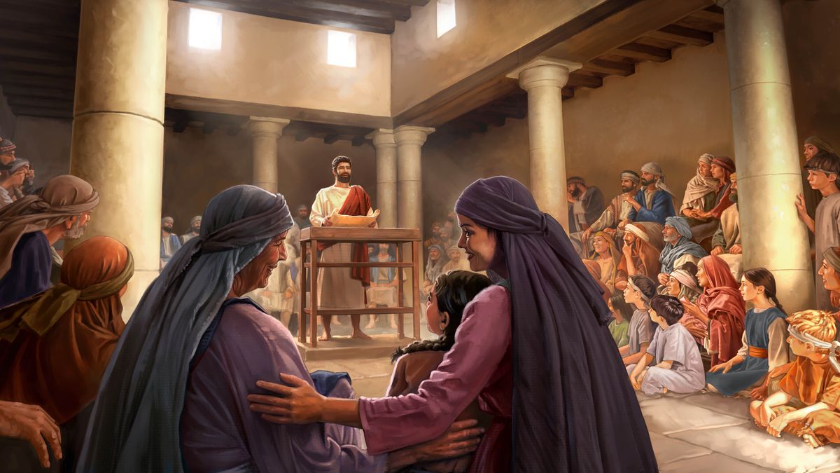 Dans une synagogue, Jésus, un rouleau ouvert dans les mains, parle devant un auditoire composé d’hommes, de femmes et d’enfants qui écoutent attentivement.