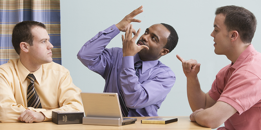 Mies tutkii Raamattua kahden Jehovan todistajan kanssa