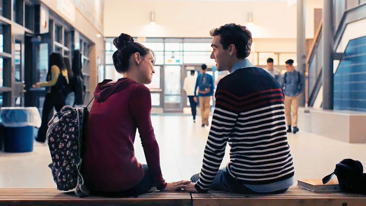 A scene from the video “God ‘Is Aware of the Secrets of the Heart.’ ” The brother sitting close to a girl at school as she touches his hand.