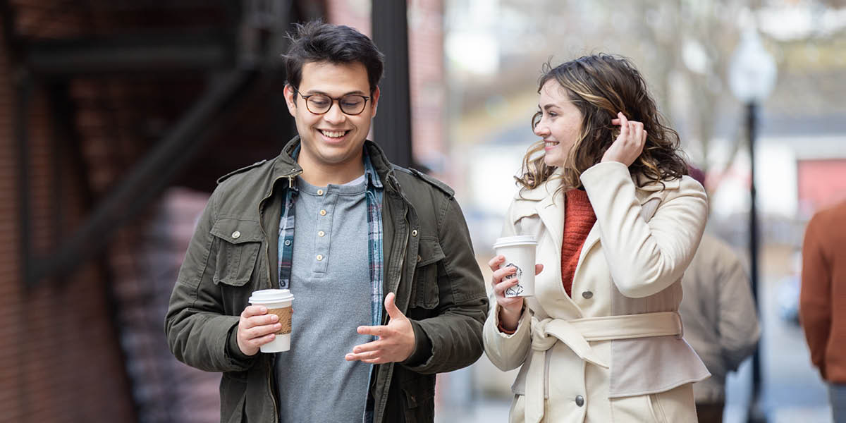 One guy an one wahine walking on da street looking all happy an talking.