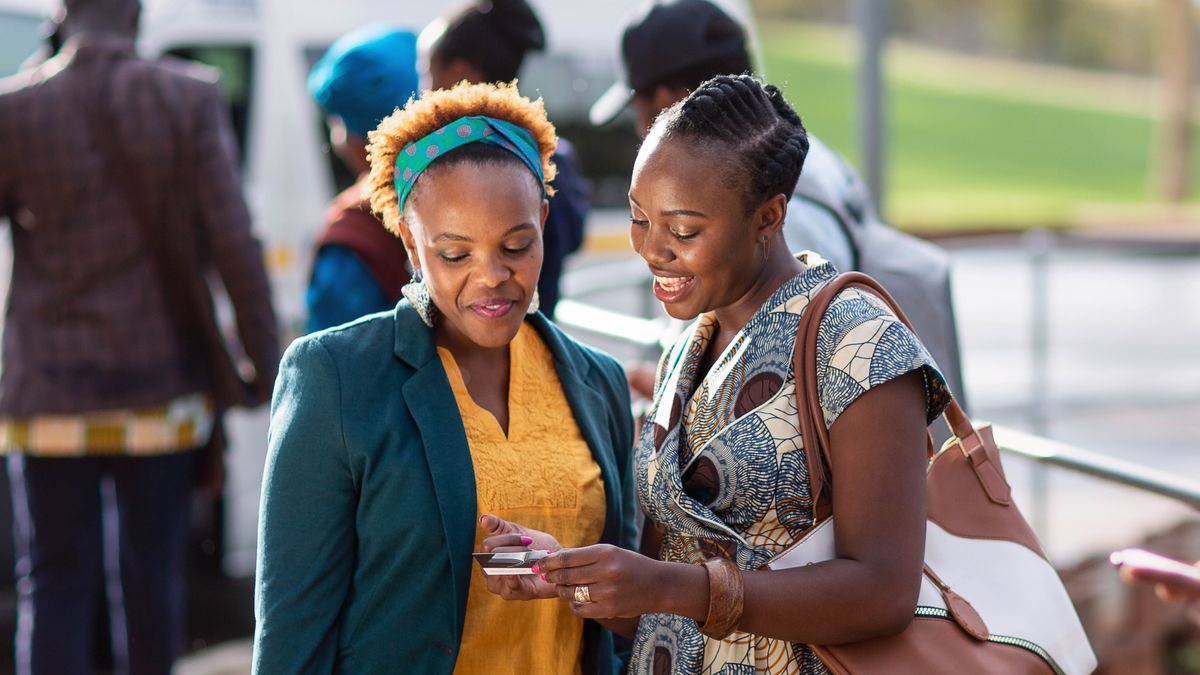 One sistah witnessing to one lady at one taxi stand.