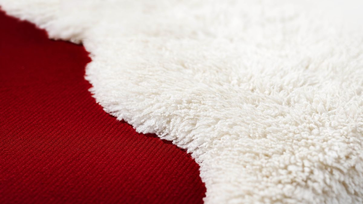 White wool nex to one dark red carpet.