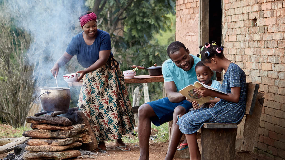 I componenti di una famiglia sono davanti alla loro casa modesta. Sono felici di quello che hanno. La madre cucina sul fuoco un piatto semplice. Lì accanto il padre studia con i due figli il libro “Impariamo dai racconti della Bibbia”.