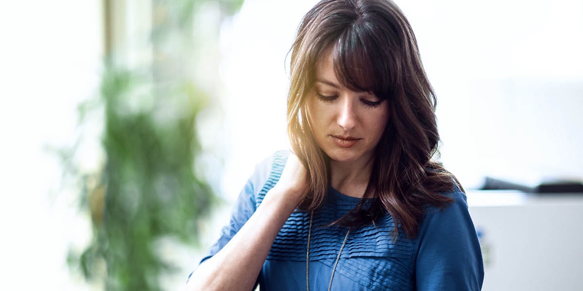 Una donna stressata per il lavoro tiene la testa bassa ed è molto triste.