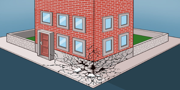 Edificio di mattoni con una crepa nelle fondamenta
