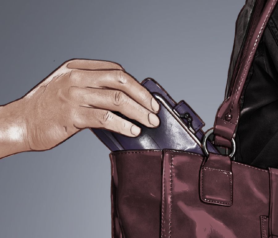 Un uomo ruba un portafoglio da una borsa