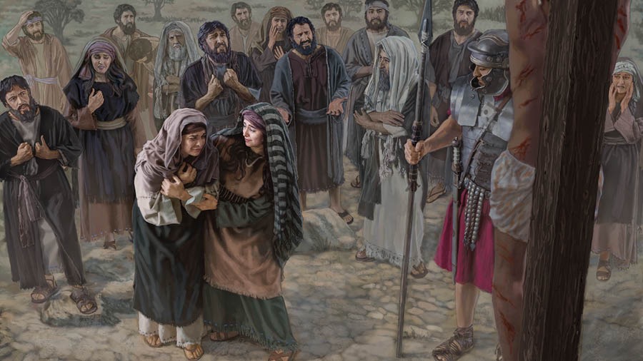Maria Magdaléna meluk ibuné Yésus ing ngarep cagak paukuman. Ana wong-wong lan tentara Roma sing ngadeg cedhak kono.