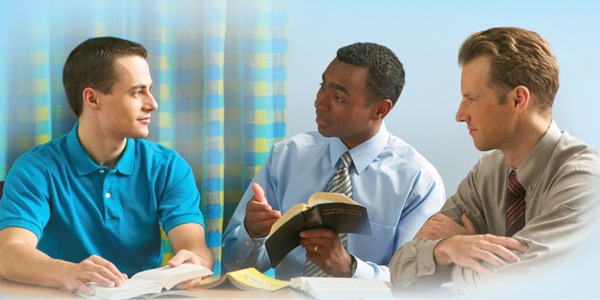 Two of Jehovah’s Witnesses studying the Bible with a man