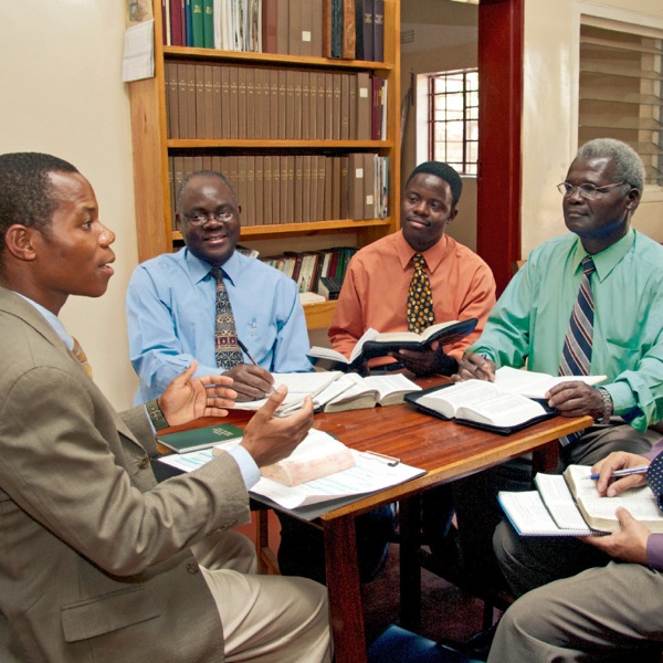 A traveling overseer meeting with the congregation elders