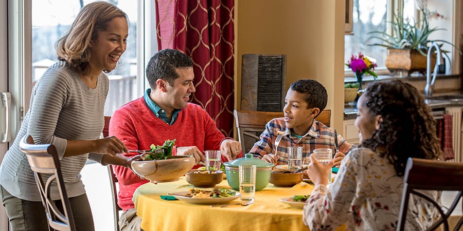 한 가족이 식사 시간에 즐겁게 대화를 나누는 모습