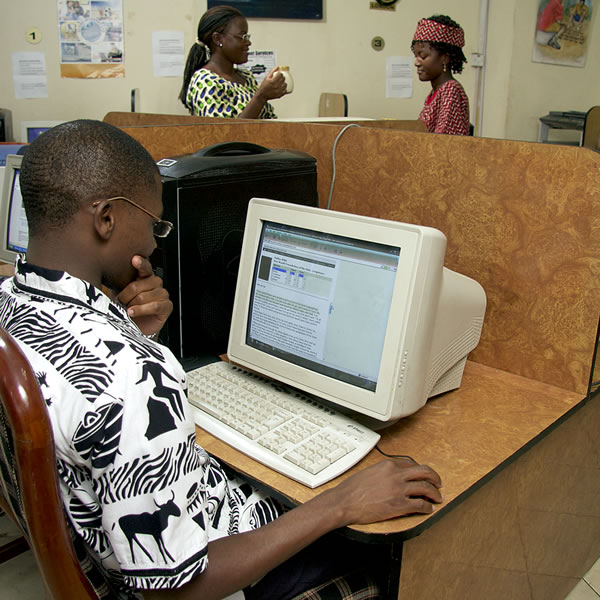A young man viewing information on a computer screen