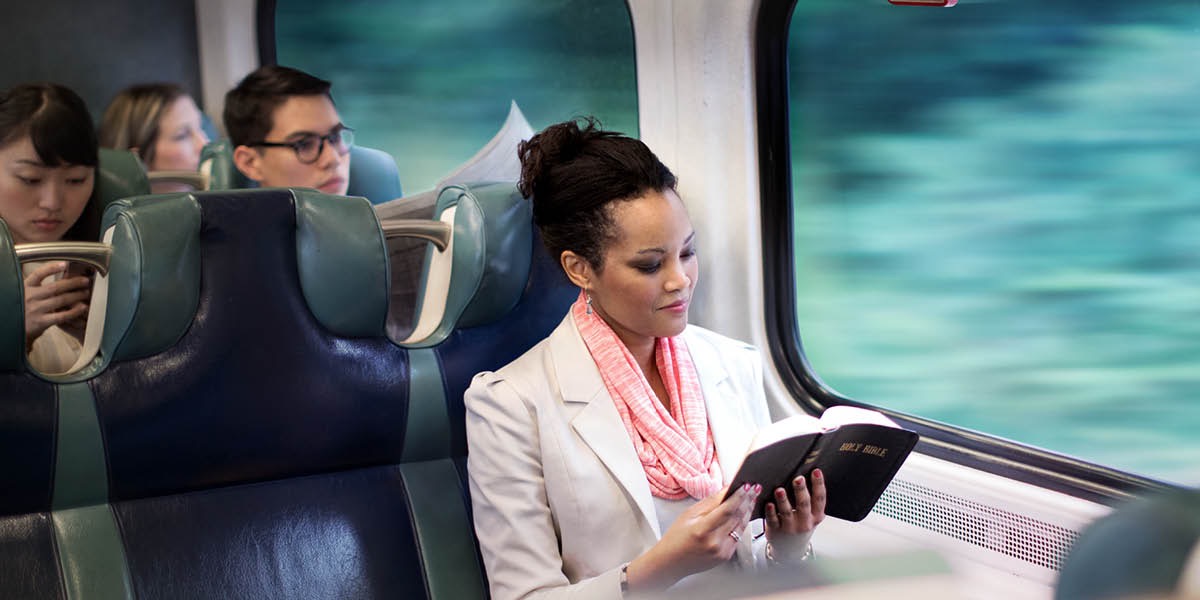 Omukazi asoma Bayibuli ng’ali mu gaali y’omukka