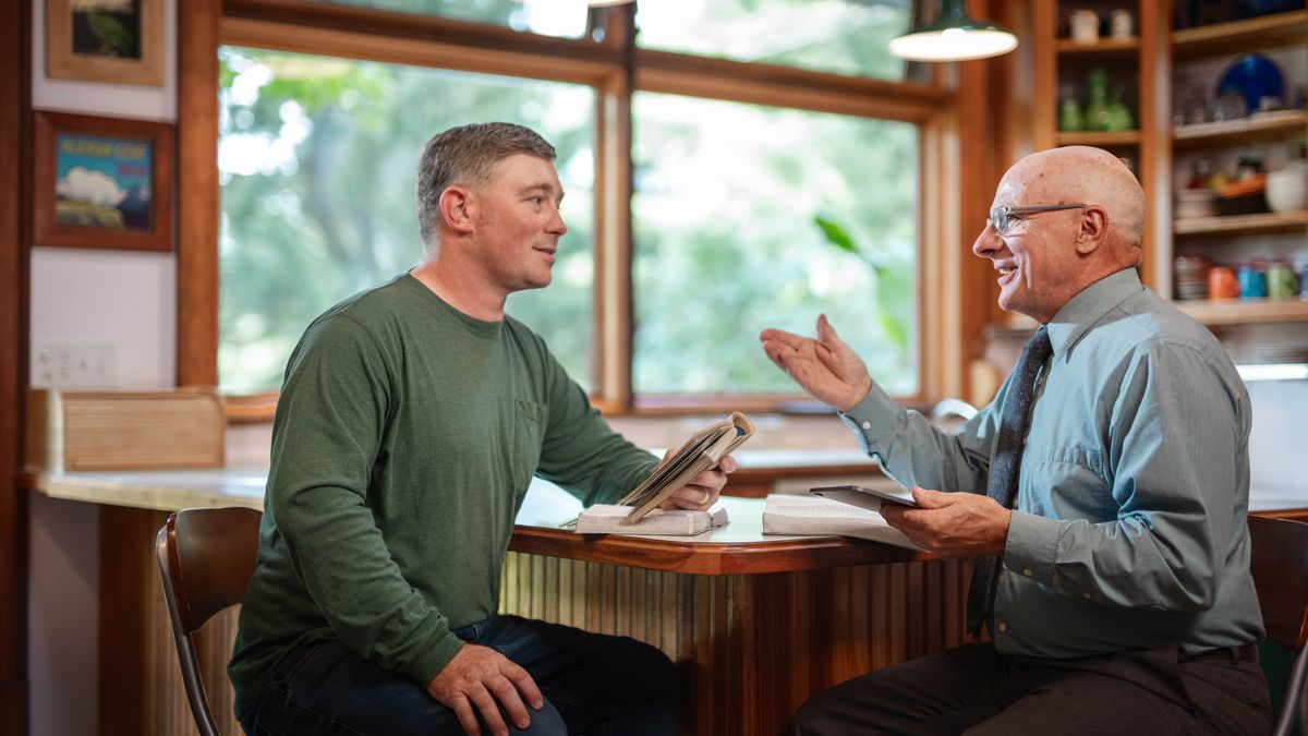 An older brother visits another brother in his home and gives him Scriptural encouragement.