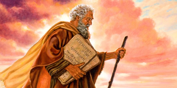 Moses holds the two stone tablets containing the Ten Commandments