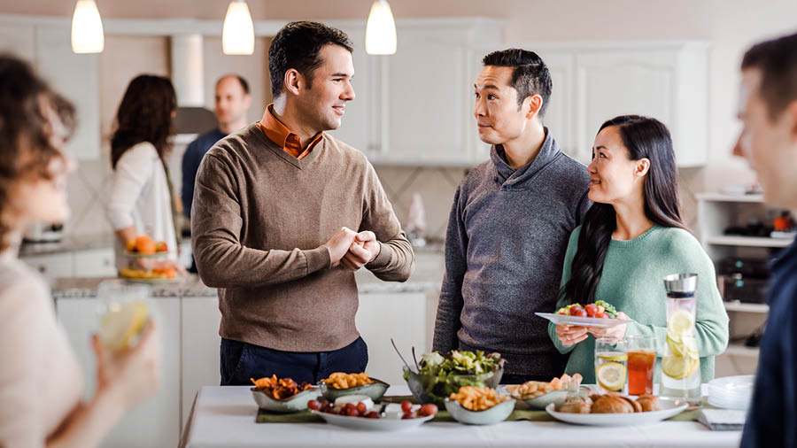 The brother conversing with others from the congregation at a social gathering.