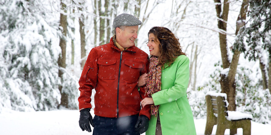 A happily married couple walking in the snow