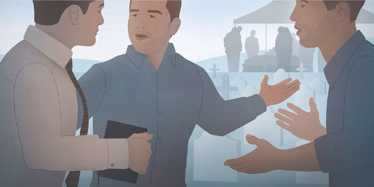 Dois homens em um cemitério conversam com uma Testemunha de Jeová. Um deles aponta para o funeral ao fundo.