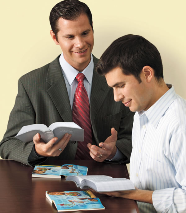 Two men studying the Bible using the Bible Teach book
